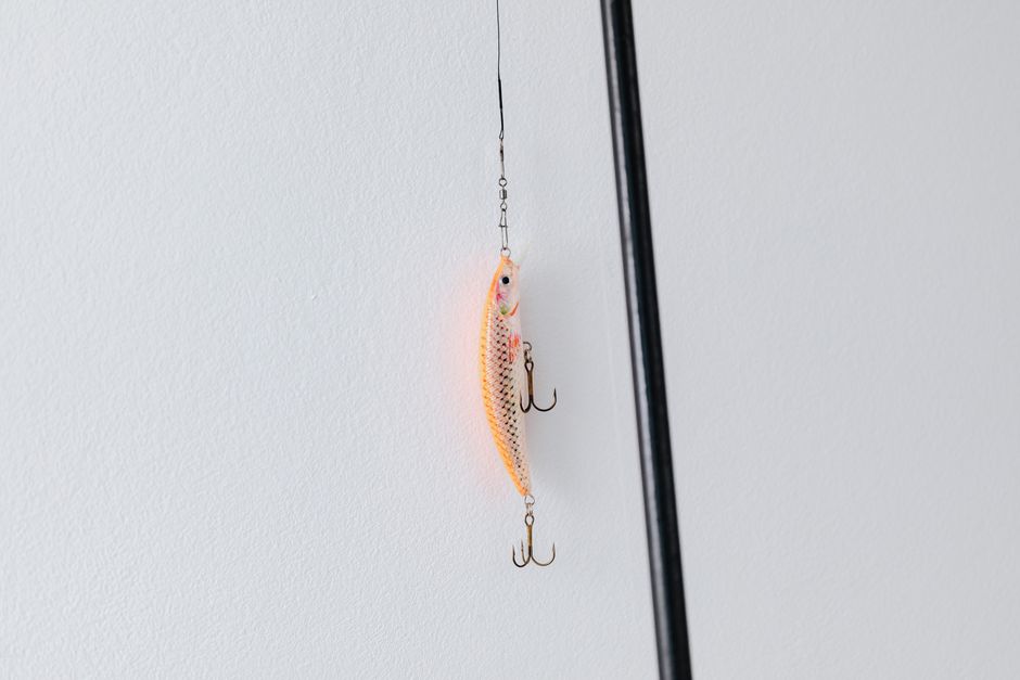 Detailed close-up of a fishing lure attached to a fishing rod, perfect for angling or fishing enthusiasts.